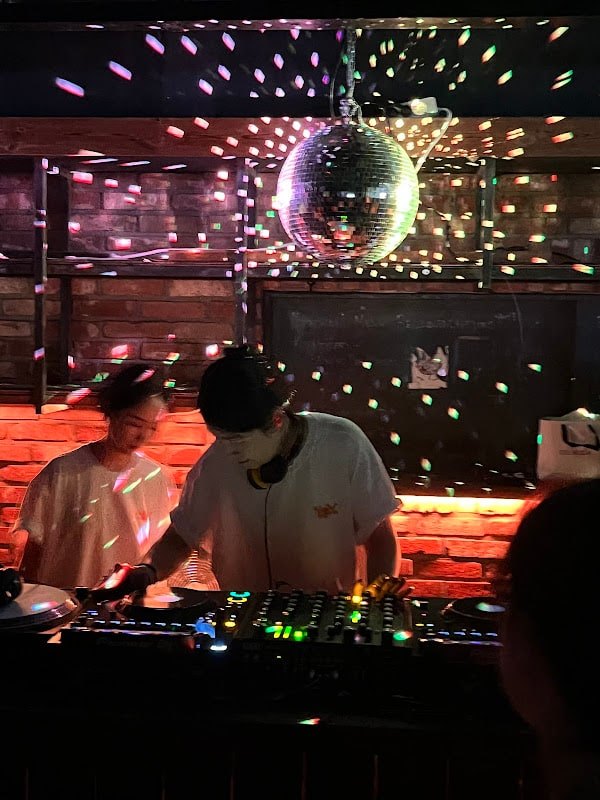 A live DJ set at NYAPI beneath the mirror ball.